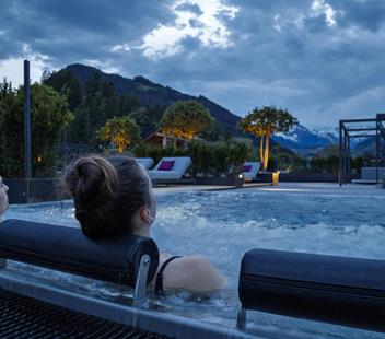 Two guests relax in the jacuzzi sky pool