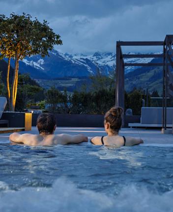 Two guests relax in the jacuzzi sky pool