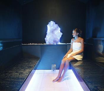 A woman in the mountain crystal steam bath