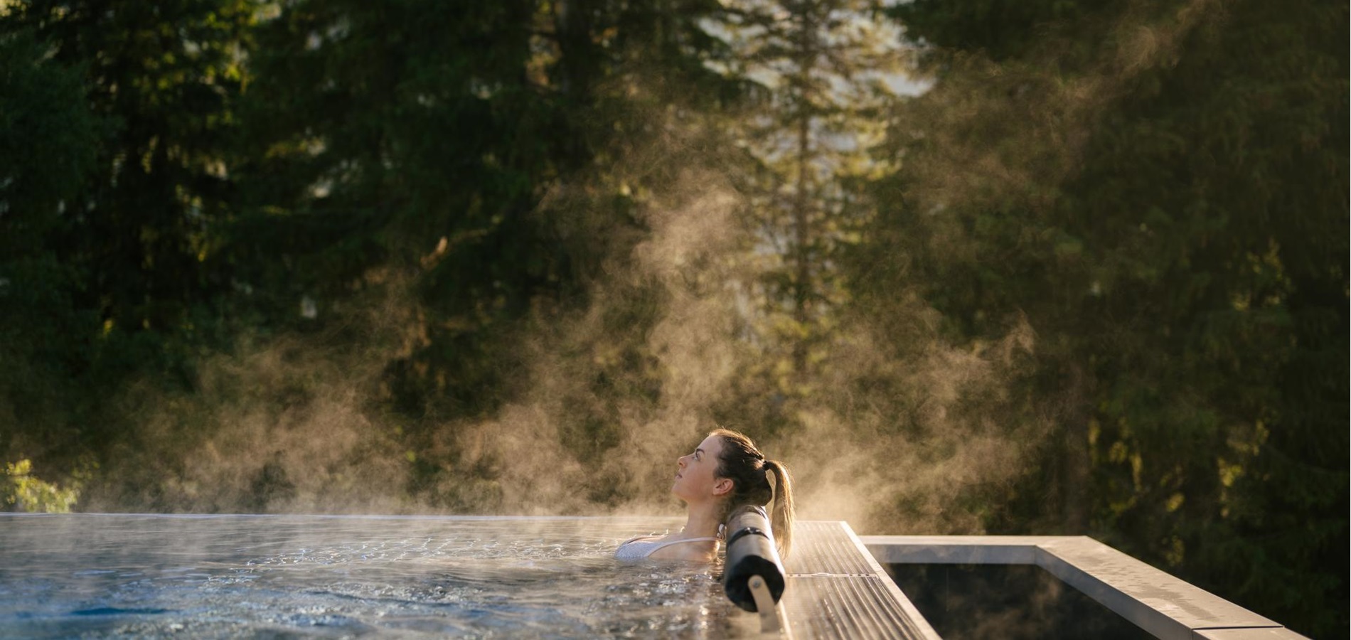 A woman relaxes in the heated sky pool