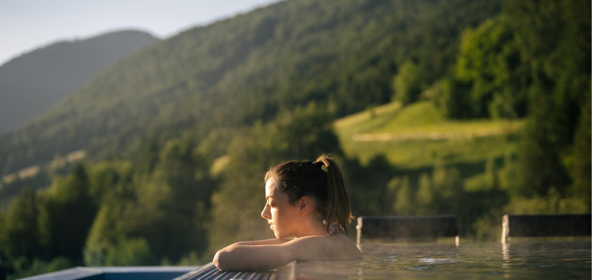 A woman relaxes in the heated sky pool